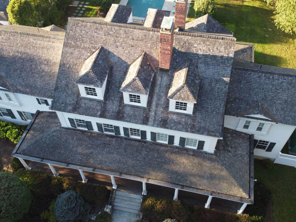 Aerial view of original cedar shingles on home before replacement