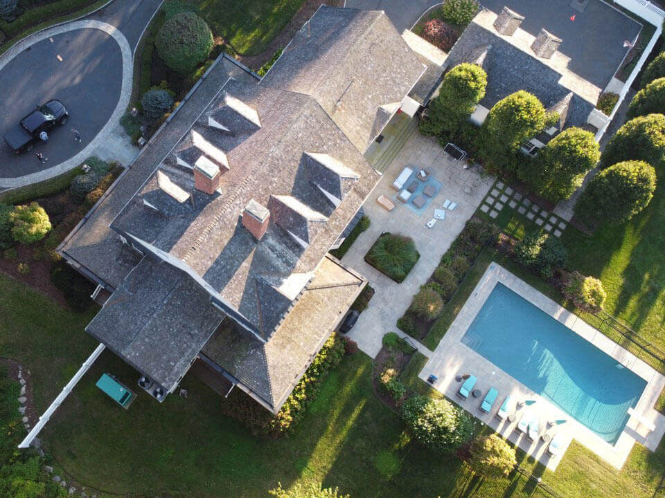 Aerial view of original cedar shingles on home before replacement