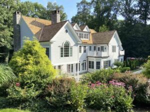 White home with tapersawn cedar roof