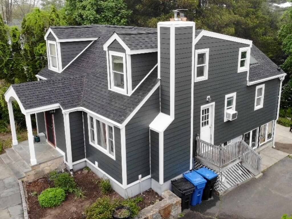 Side view of home with dark gray James Hardie siding replacement in Rye, NY