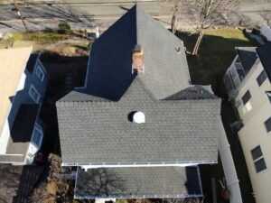 Overhead view of white home with dark gray asphalt shingles