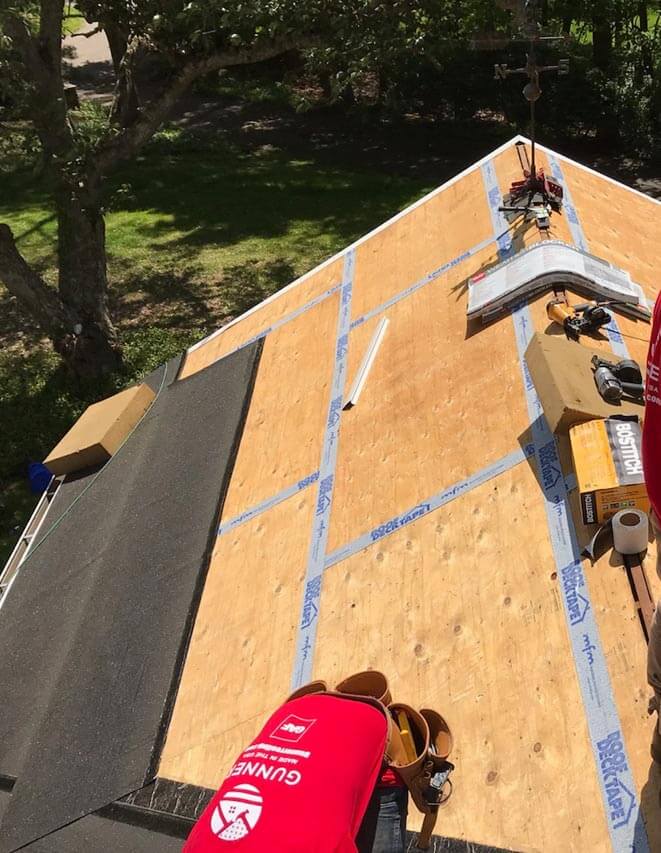 Home with fresh plywood on roof