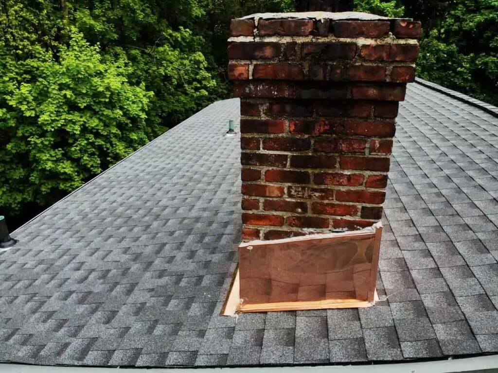 Aerial view of home with asphalt roof and copper chimney flashing in Darien, CT