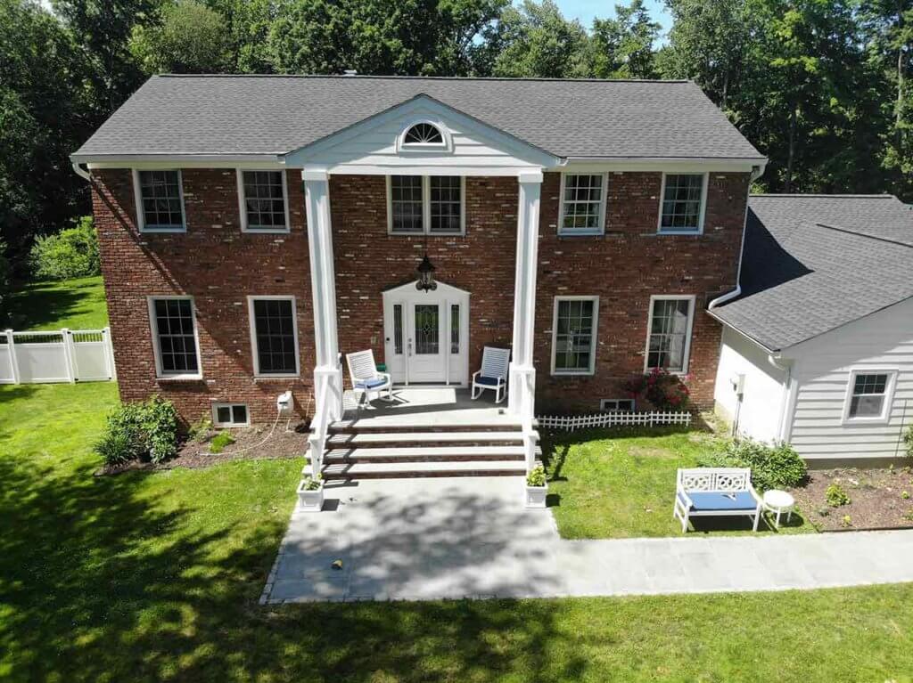 Brick home with James Hardie siding on garage