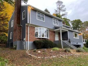 Front view of James Hardie siding on home with autumn foliage on trees in background