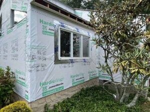 Newly installed windows and siding repair in progress