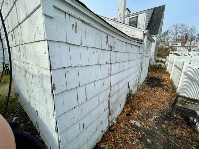 Closeup of damaged siding on home