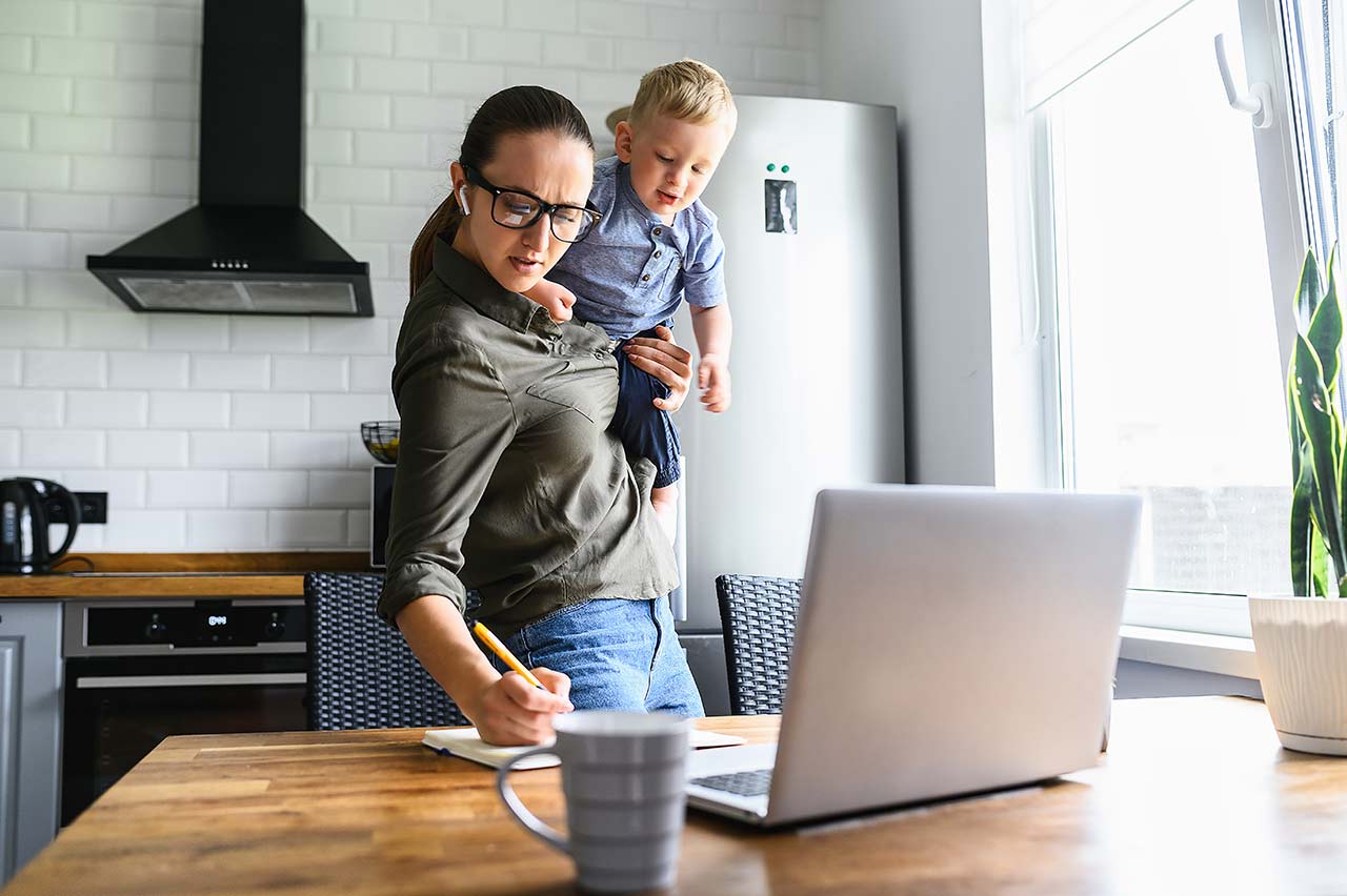 Busy mom holding child while working to get a roofing quote