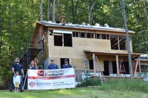 Gunner team in front of Habitat for Humanity home