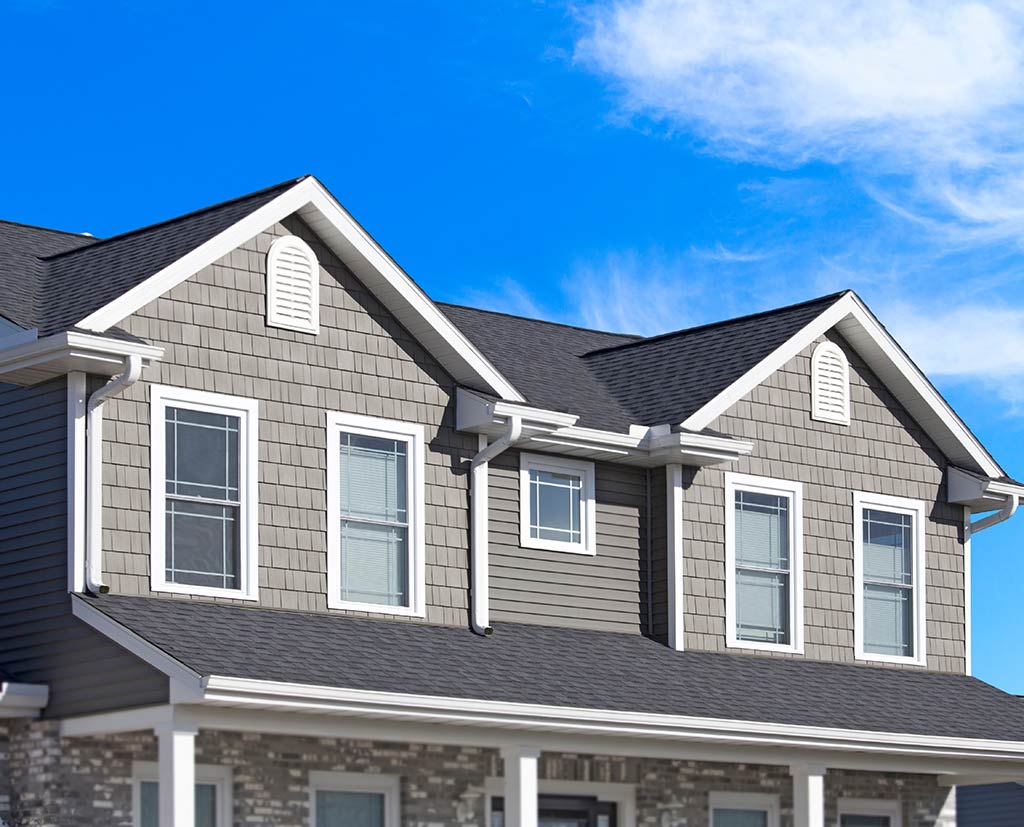 side view of home with asphalt roof