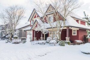 side view of red house covered in snow