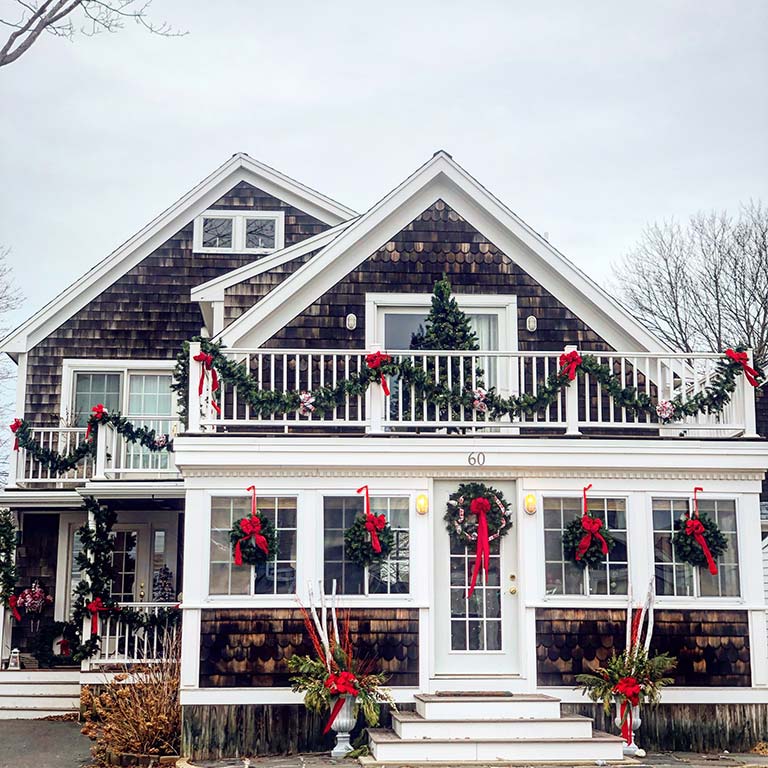 House with lots of Christmas wreaths.