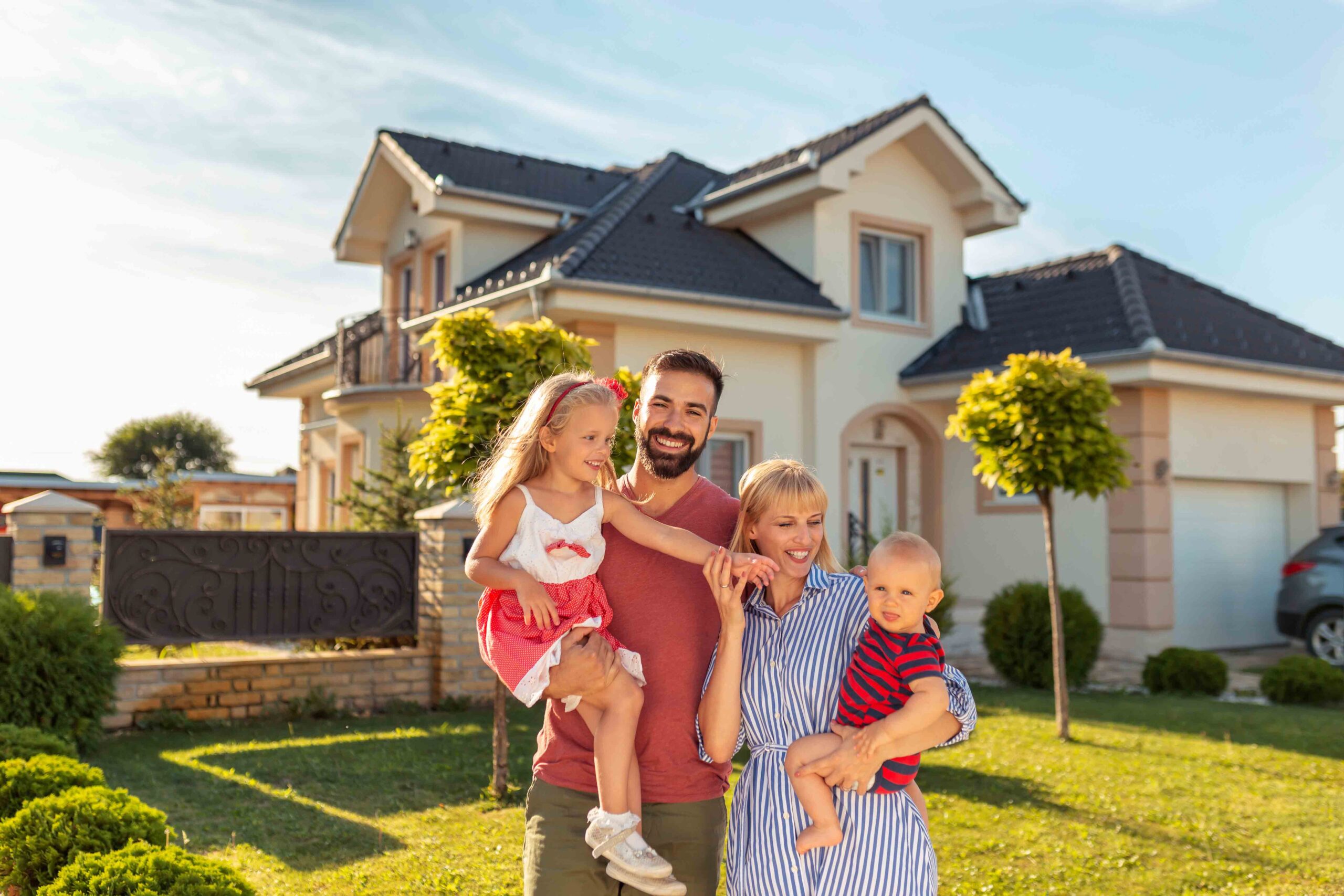 family in front of house